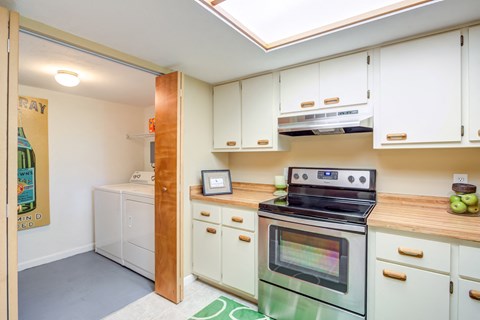 a kitchen with white cabinets and a green oven and stove