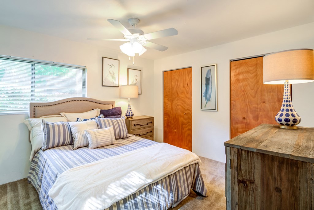 a bedroom with a large bed and a ceiling fan
