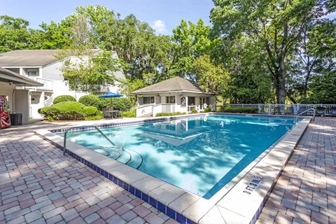 a swimming pool with a house in the background