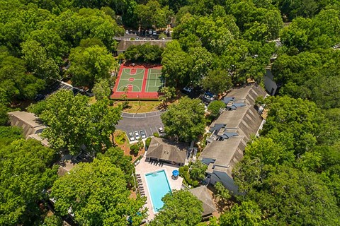 an aerial view of several houses and a basketball court