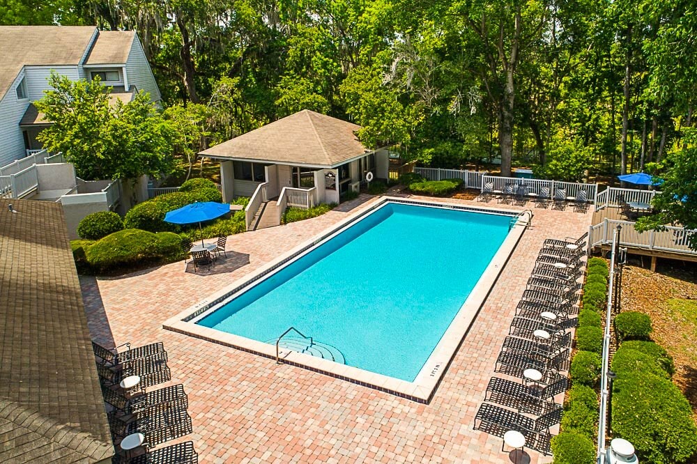 a swimming pool in a backyard with a house