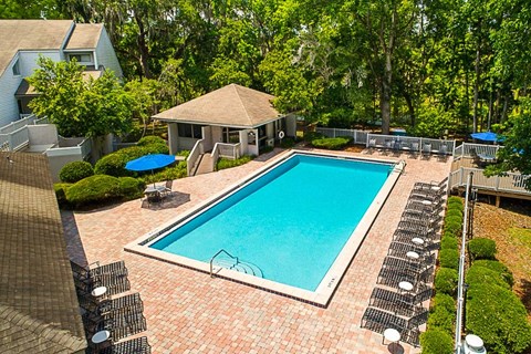 a swimming pool in a backyard with a house