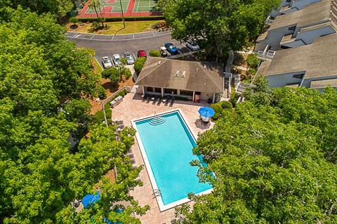 an aerial view of a swimming pool and a house