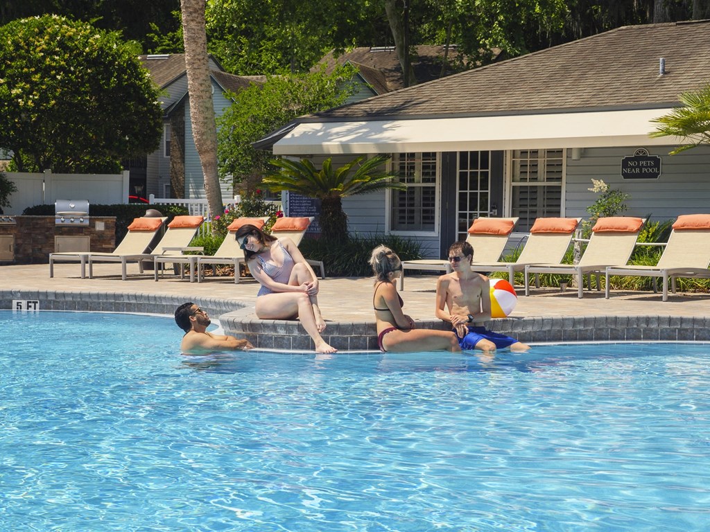a group of people sitting in a swimming pool