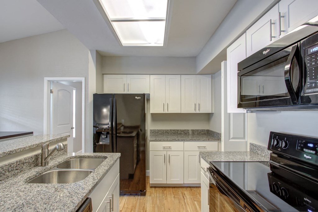 a kitchen with granite counter tops and stainless steel appliances