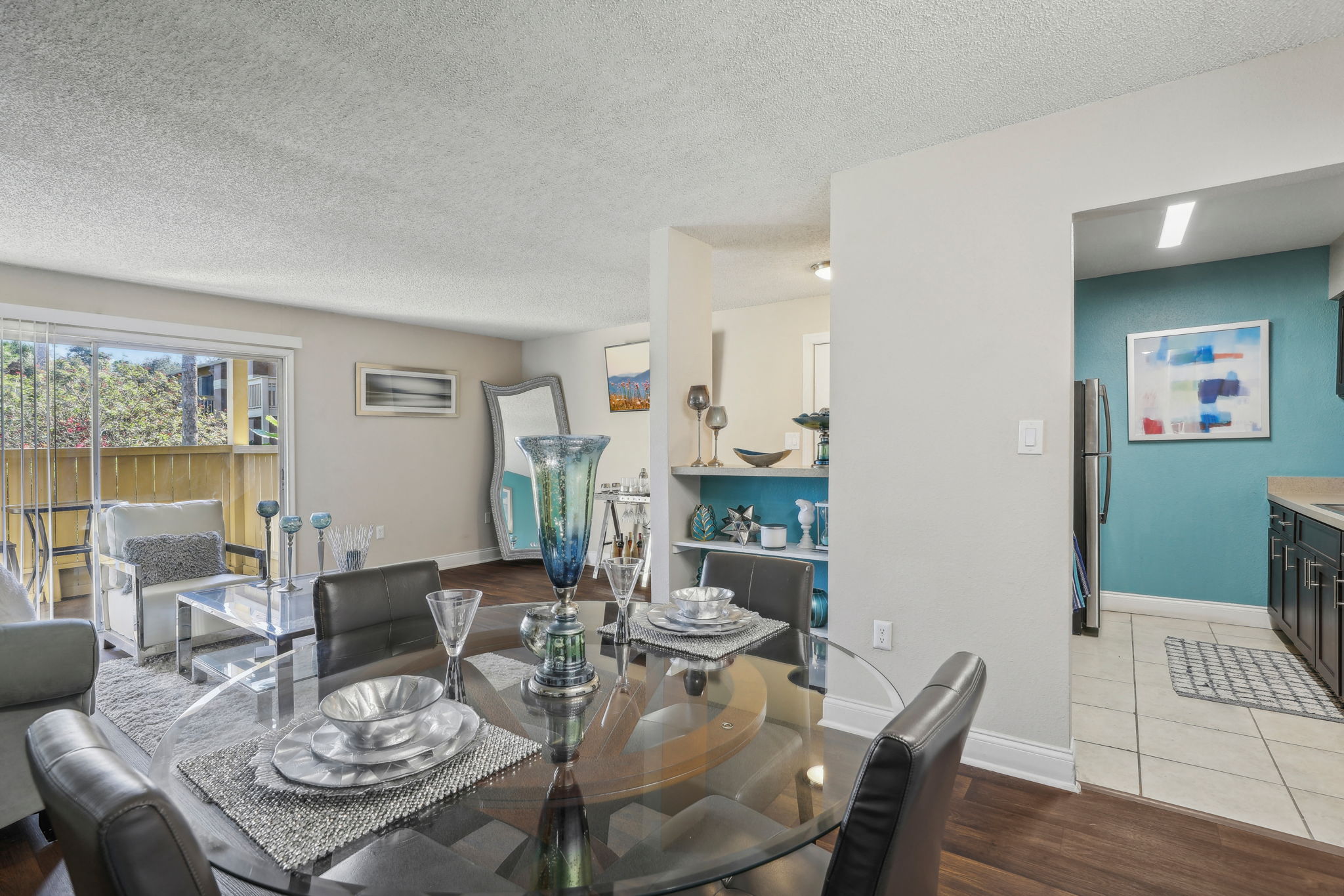 A dining room with a glass table and chairs.