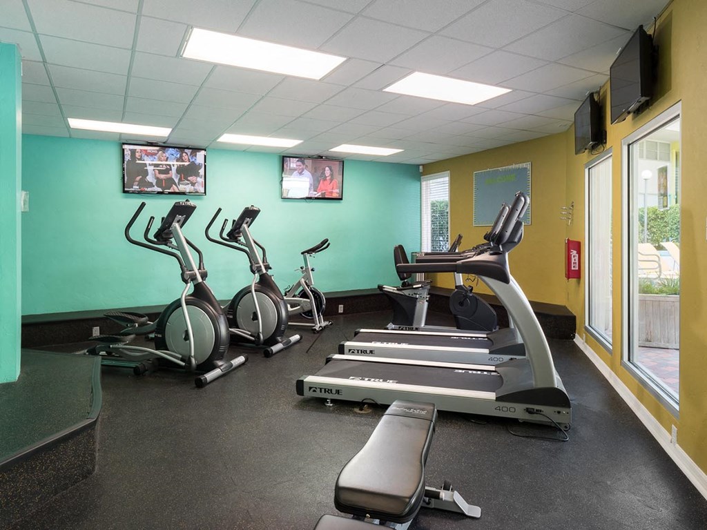 a gym with treadmills and other exercise equipment