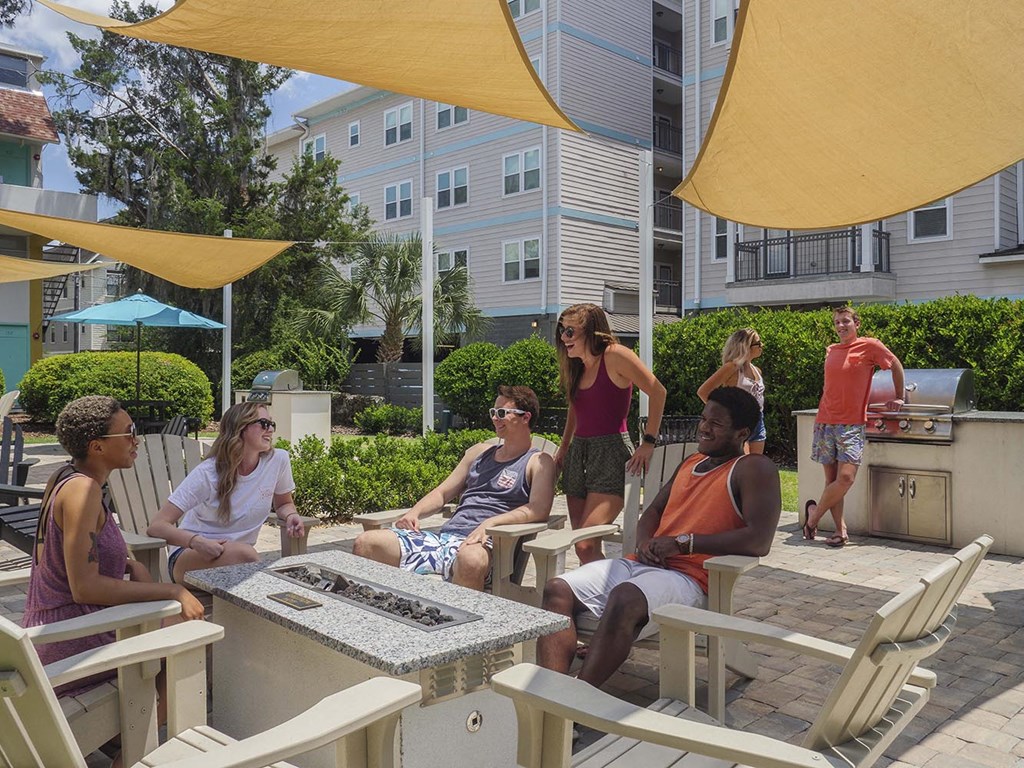 a group of people sitting around a table in a patio