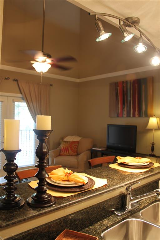 Kitchen with granite countertops and living room