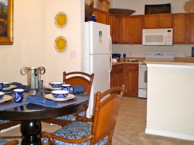 a kitchen with a table and chairs and a refrigerator
