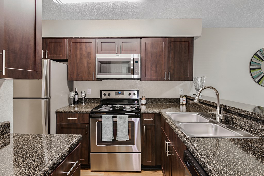 a kitchen with granite counter tops and stainless steel appliances