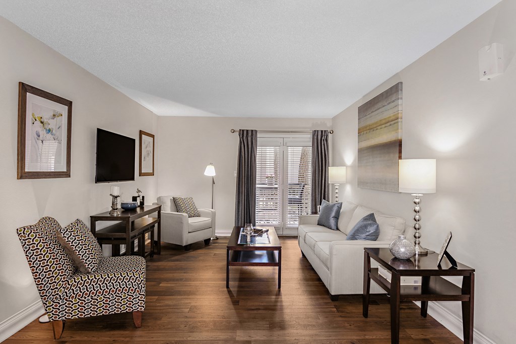 a living room with a couch and chairs and a table