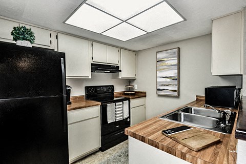 a kitchen with a sink and a refrigerator