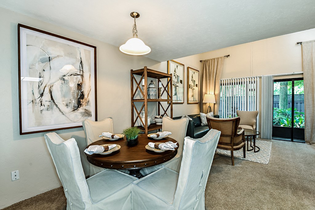 a dining room with a table and chairs
