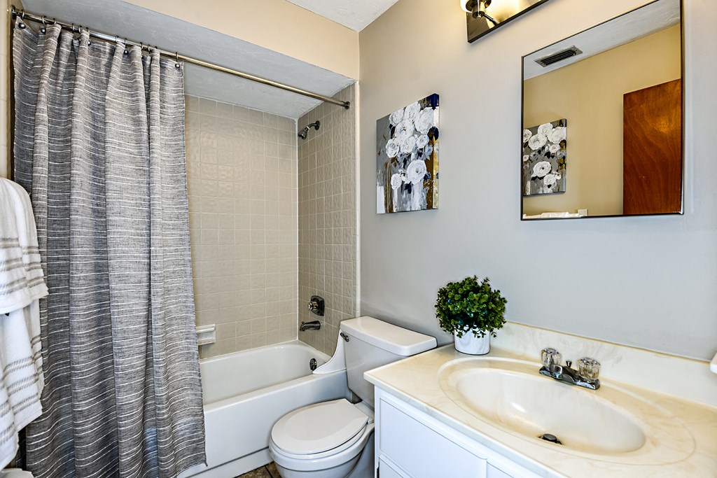 a bathroom with a sink toilet and a tub