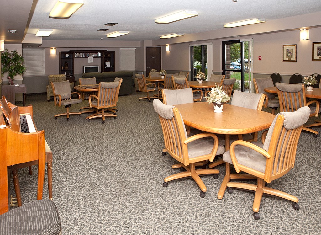 a dining room with tables and chairs in a large room
