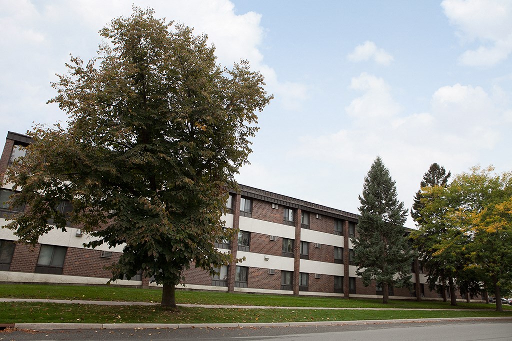 a large brick building with trees in front of it