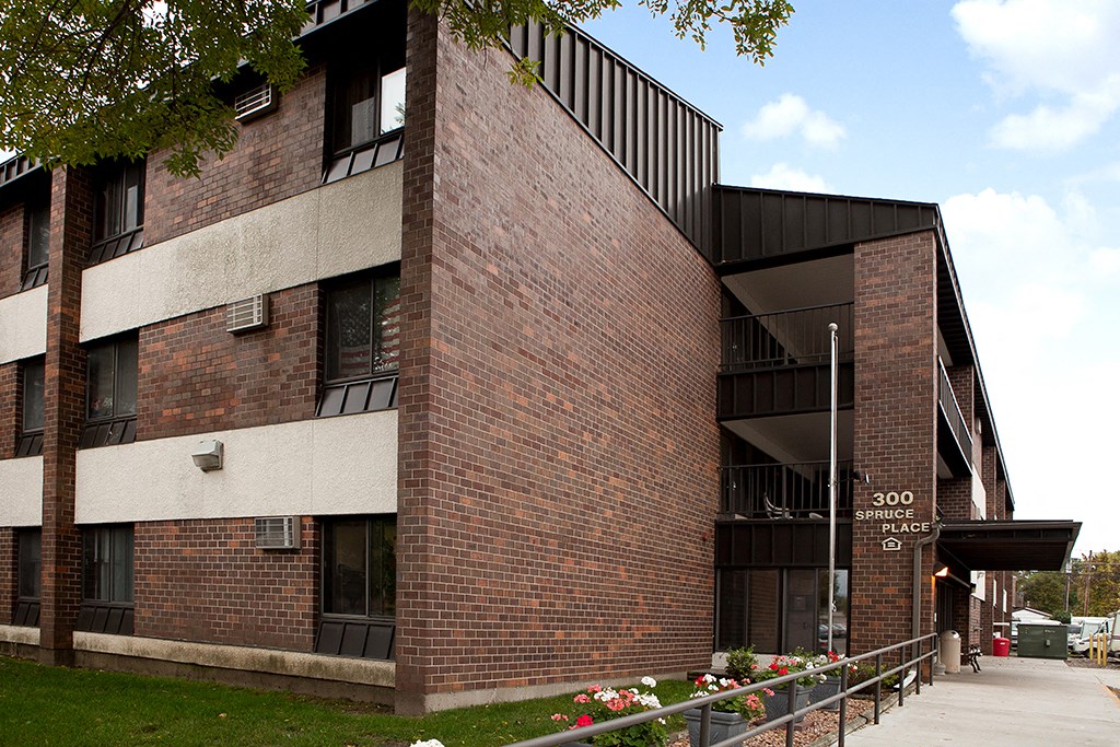 a brick building with a sidewalk in front of it
