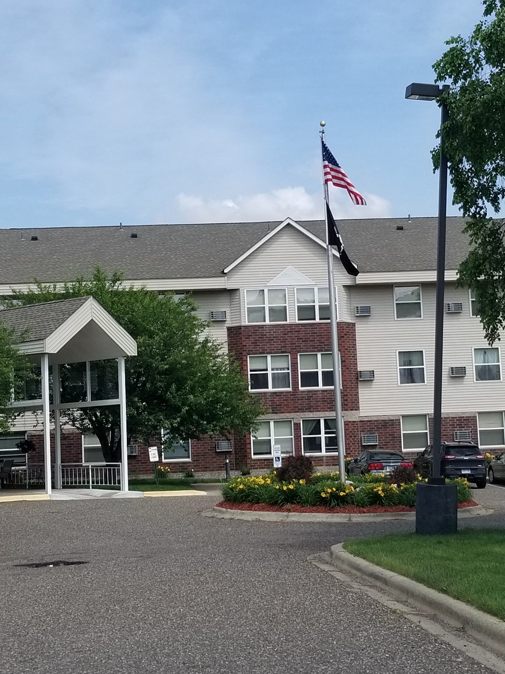 an flag flying in front of an apartment building