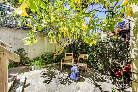 A small patio with a chair and table.