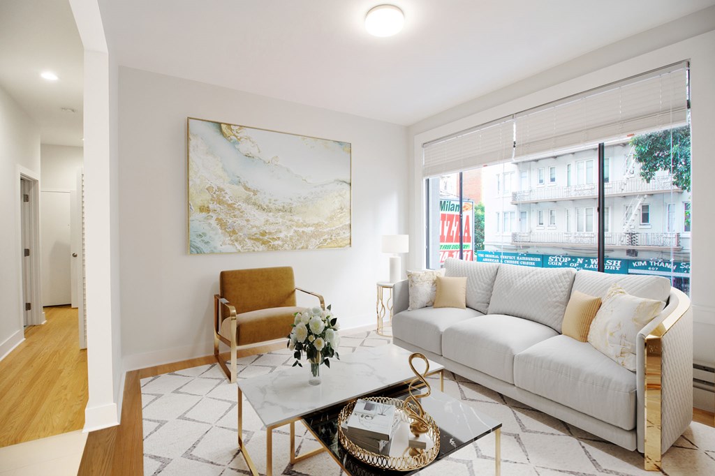 a living room with a white couch and a glass coffee table
