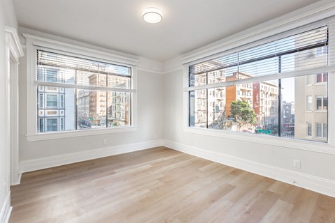 A room with a large window overlooking a cityscape.