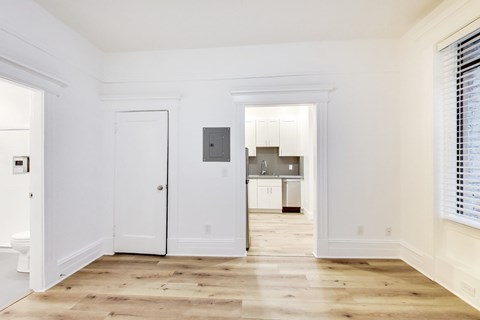 A white door is in the middle of a room.