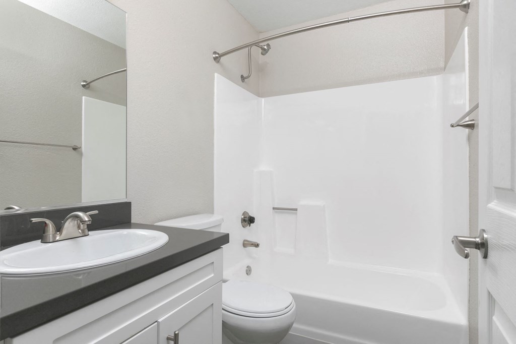a white bathroom with a sink and a toilet