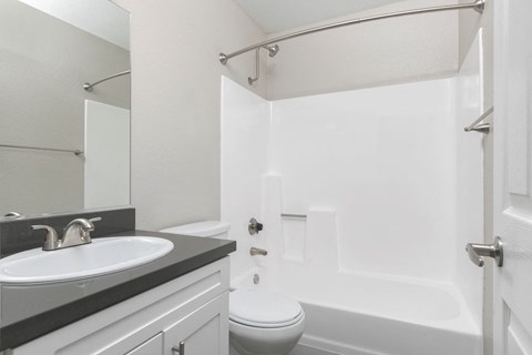 a white bathroom with a sink and a toilet