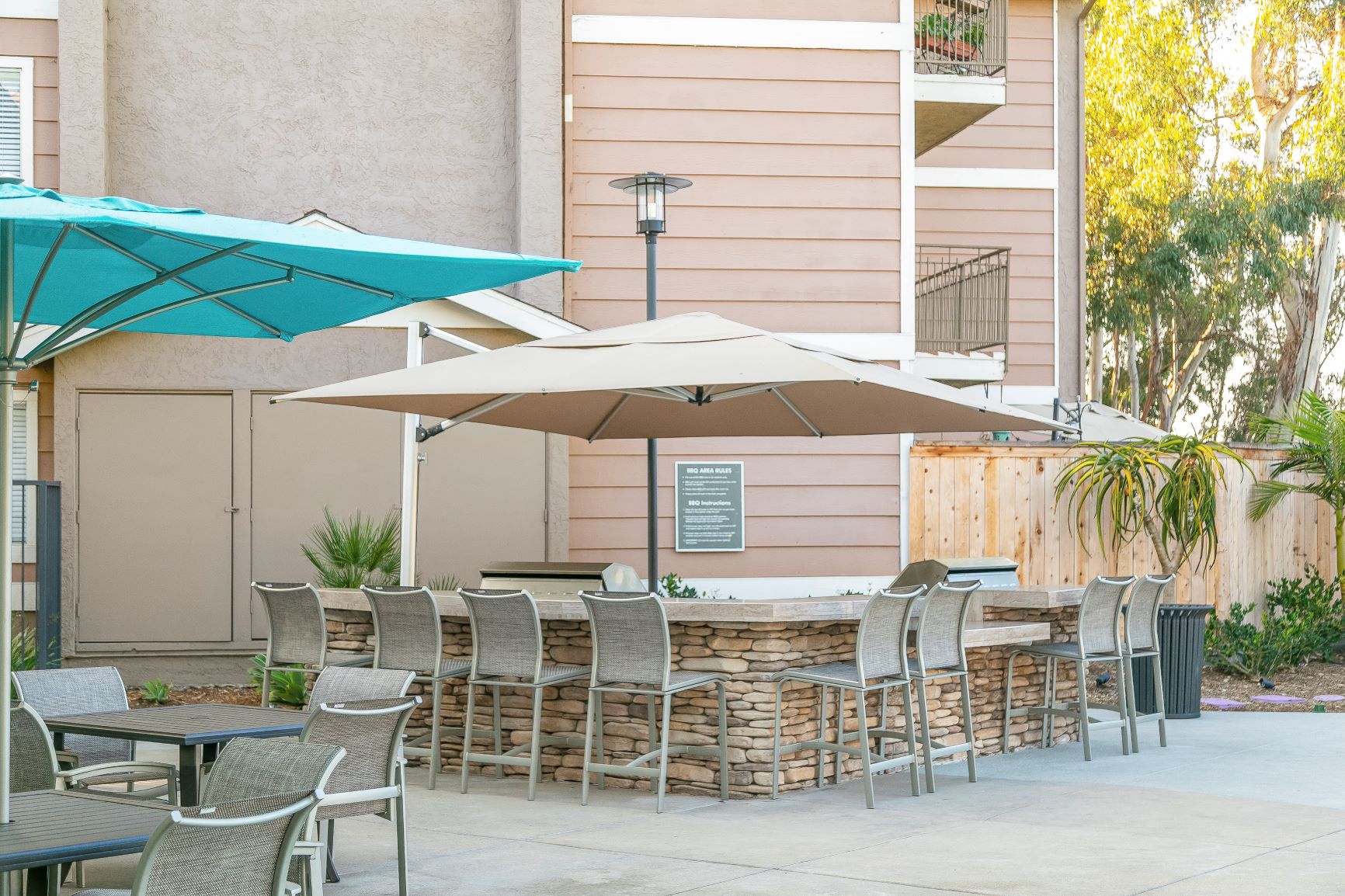 a patio with tables and chairs and umbrellas