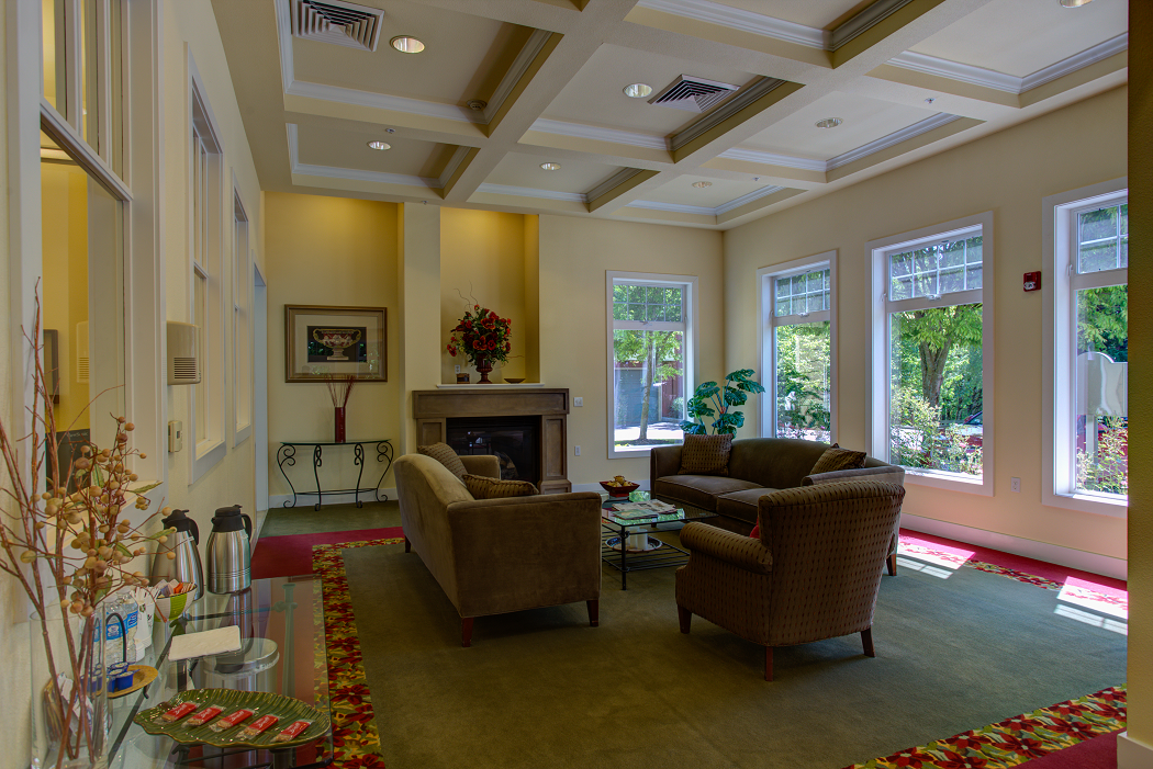 a living room with couches and chairs and a fireplace