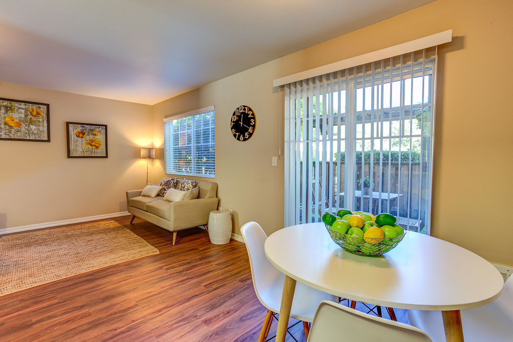 a dining area with a table and chairs and a living room with a couch