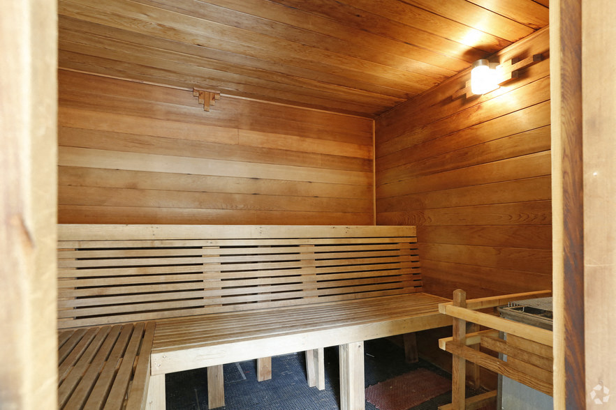 a sauna with wooden benches and a table