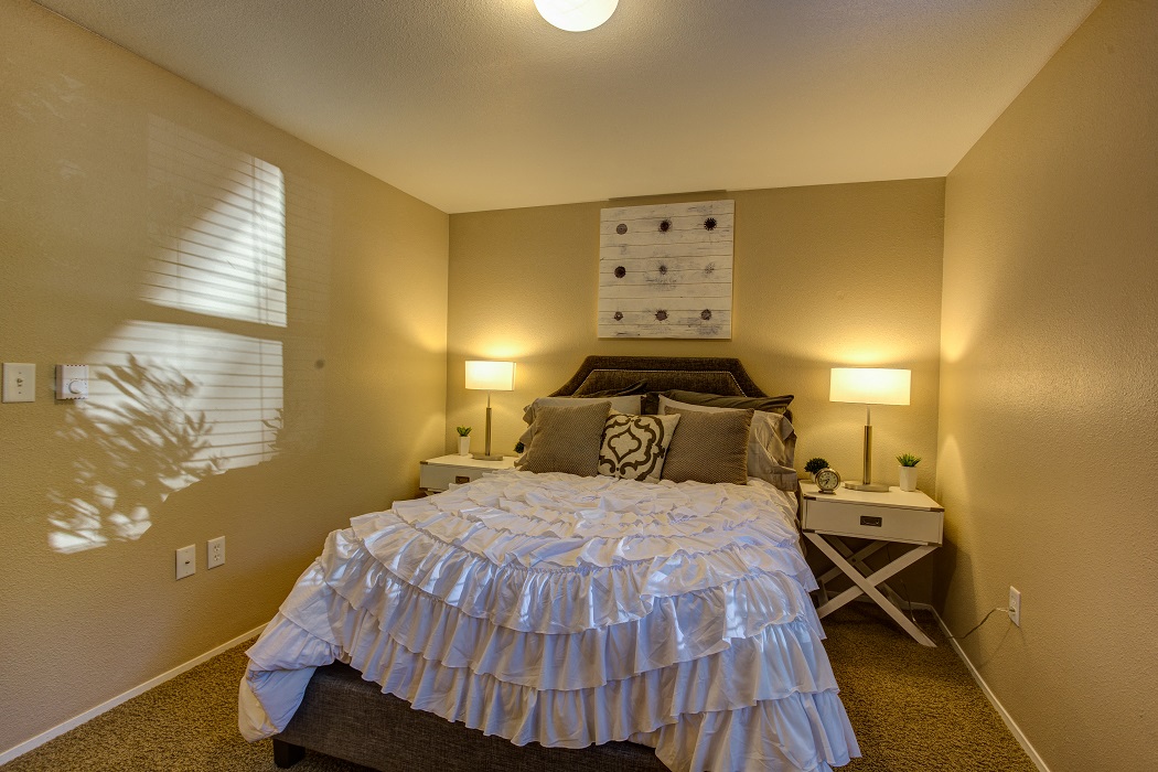 a bedroom with a bed and a window