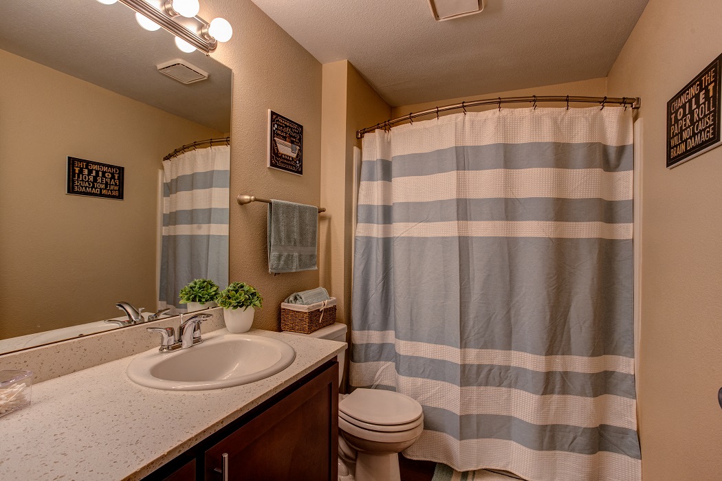 a bathroom with a shower and a sink and a toilet