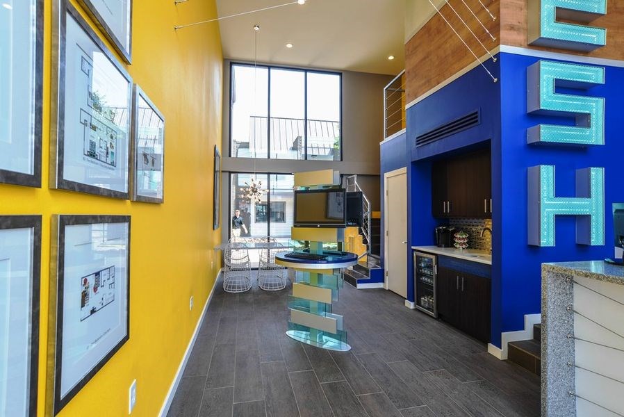 a kitchen and dining area in a hotel with a blue and yellow wall