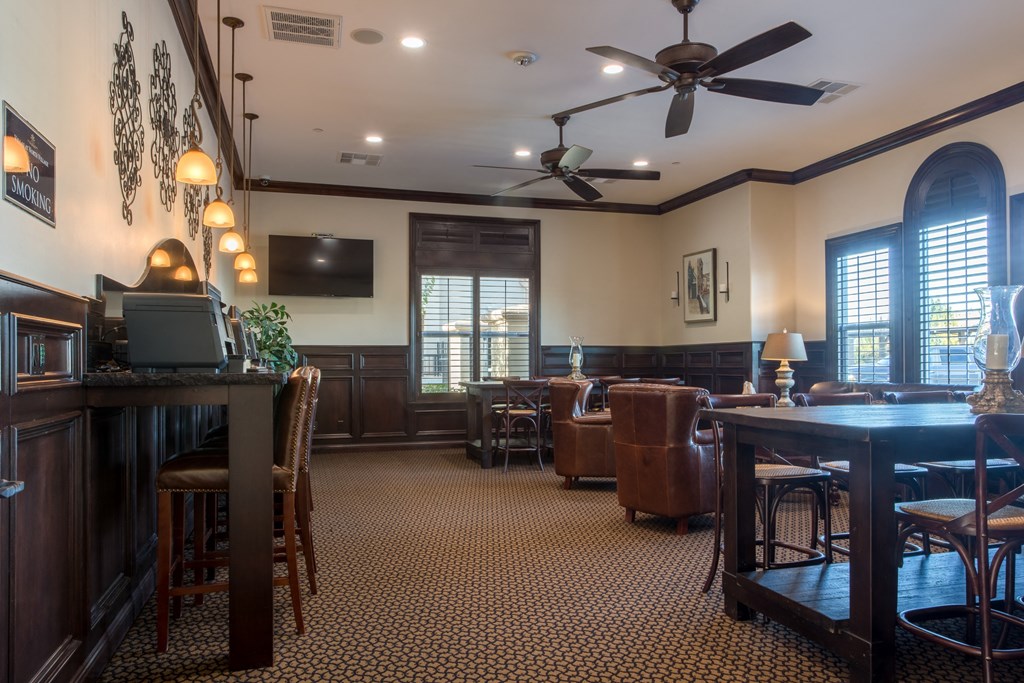 a dining room with a table and chairs and a ceiling fan