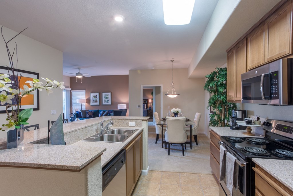 a kitchen and dining area with a table and chairs and a sink