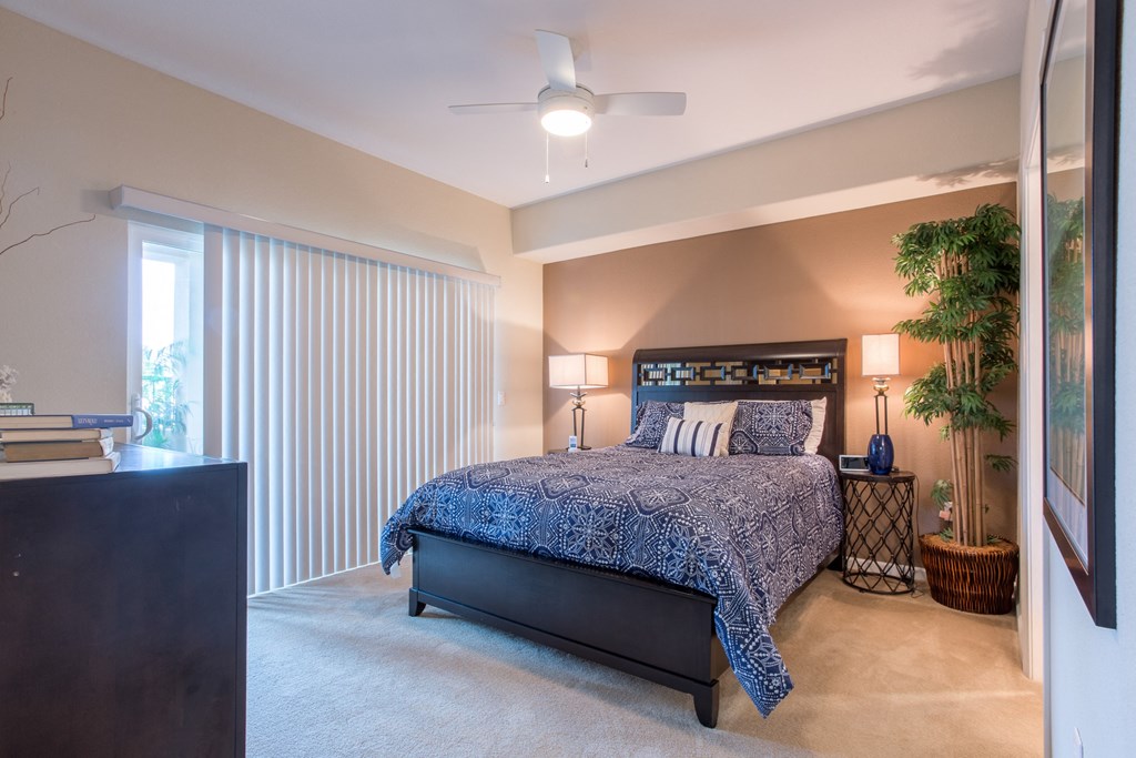 a bedroom with a bed and a ceiling fan