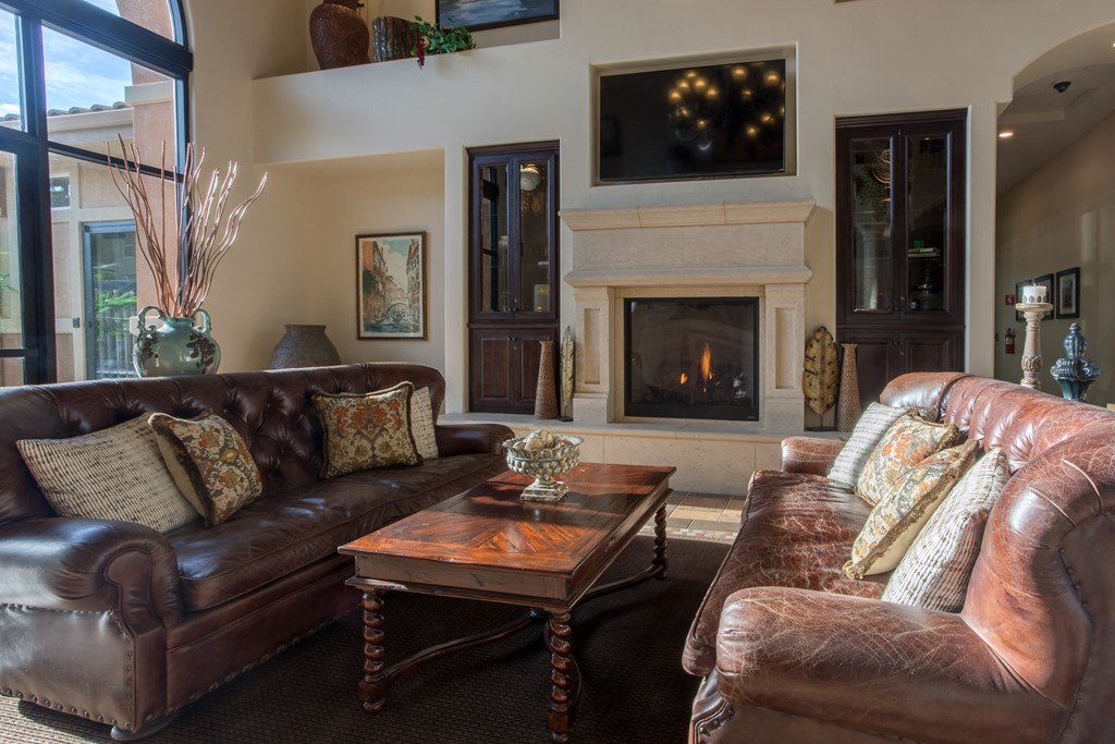 a living room with leather furniture and a fireplace