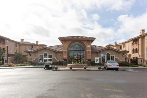a large building with cars parked in a parking lot