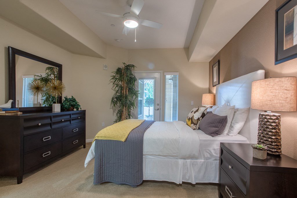 a bedroom with a large bed and a ceiling fan