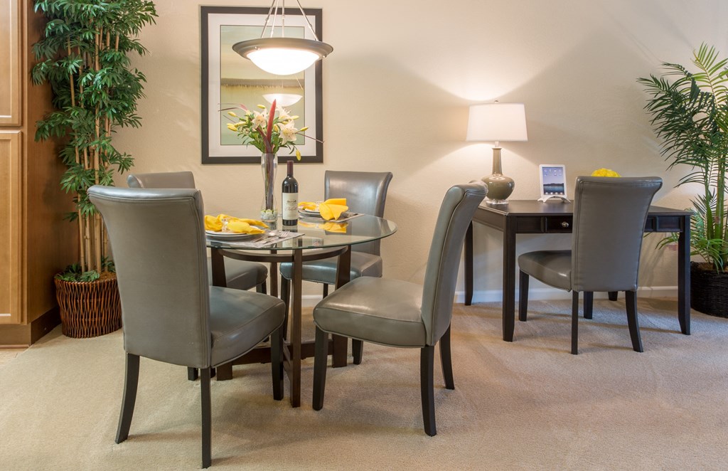 a dining room with a table and chairs