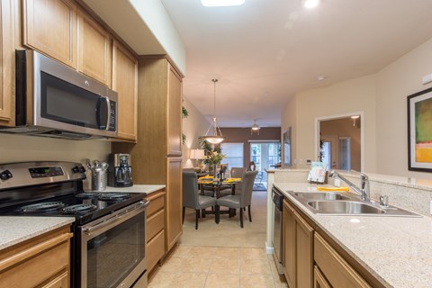 kitchen with stainless steel appliances and granite counter tops and a dining room with a table