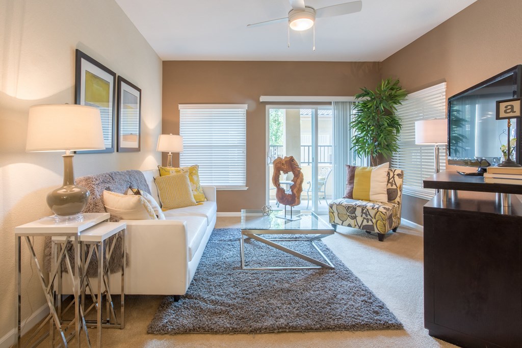 a living room with a couch and a chair and a window