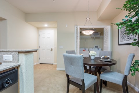 a dining room and kitchen with a table and chairs