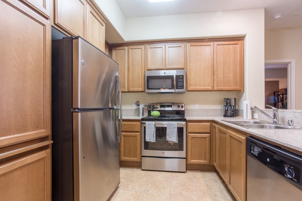 a kitchen with stainless steel appliances and wooden cabinets