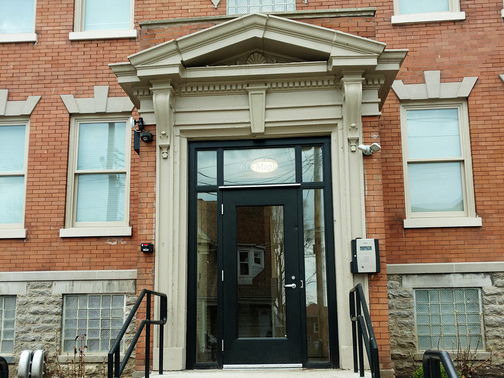 the entrance to a brick building with a black door