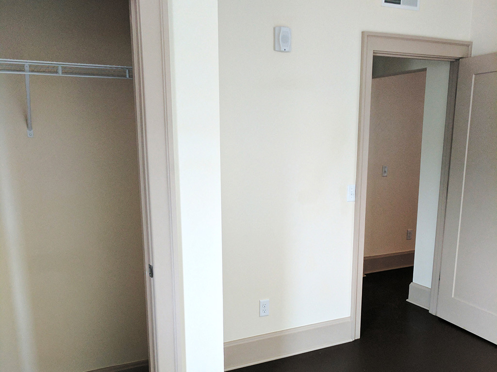 an empty room with a closet and a mirror