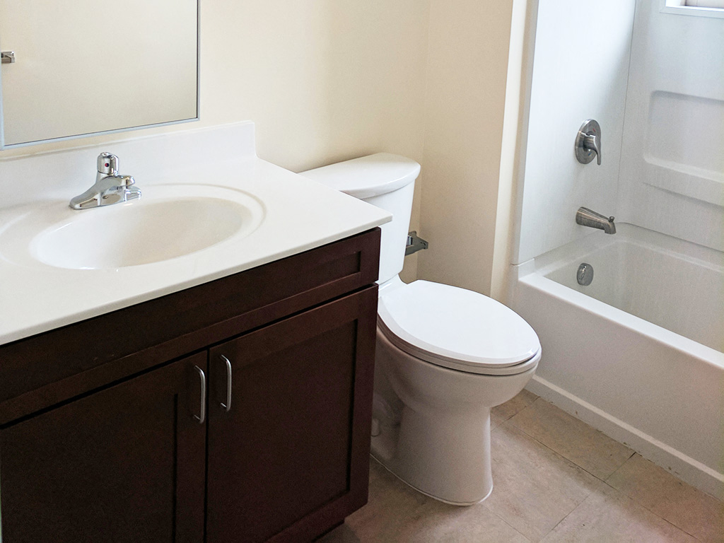 a bathroom with a sink toilet and a bath tub